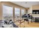 Bright living room features a grand piano, black leather sofa, and panoramic ocean views at 951 N Atlantic Ave, New Smyrna Beach, FL 32169