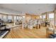 Open-concept living area with beach views, light wood floors, a piano, modern seating, and an airy kitchen at 951 N Atlantic Ave, New Smyrna Beach, FL 32169