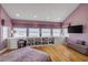 Inviting main bedroom featuring hardwood floors, built in shelving, large windows with ocean views and stylish décor at 951 N Atlantic Ave, New Smyrna Beach, FL 32169