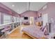 Spacious main bedroom with many windows, hardwood floors, built-in bookcases, and a view of the ocean at 951 N Atlantic Ave, New Smyrna Beach, FL 32169