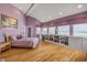 Relaxing main bedroom offering ocean views, built-in bookcases, hardwood floors and a cozy seating area at 951 N Atlantic Ave, New Smyrna Beach, FL 32169