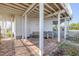 Inviting covered patio with stone flooring, seating, and direct access to the beach at 951 N Atlantic Ave, New Smyrna Beach, FL 32169
