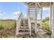 Wooden staircase leading to the beach from a beach house at 951 N Atlantic Ave, New Smyrna Beach, FL 32169