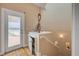 Staircase leading to a door with ocean view featuring built-in shelves and hardwood floors at 951 N Atlantic Ave, New Smyrna Beach, FL 32169