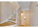 Bright, modern staircase featuring hardwood steps and white risers and handrail at 951 N Atlantic Ave, New Smyrna Beach, FL 32169
