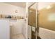 Bathroom featuring a walk-in shower and washing machine, all in a compact layout at 98 Cypress Pond Rd, Port Orange, FL 32128