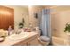 Bathroom featuring a blue shower curtain, marble countertop, and coastal themed decor at 98 Cypress Pond Rd, Port Orange, FL 32128