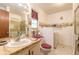 Bathroom with a sink, toilet, and walk-in shower, with unique nautical wallpaper at 98 Cypress Pond Rd, Port Orange, FL 32128