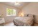 Bedroom showcasing a window view, ceiling fan, and a comfortable floral-patterned bed at 98 Cypress Pond Rd, Port Orange, FL 32128