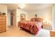 Bedroom features floral bedding, wood furnishings, and access to the Primary bathroom at 98 Cypress Pond Rd, Port Orange, FL 32128