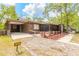 Beautiful brown home with a front porch, landscaped with flowers and gravel at 98 Cypress Pond Rd, Port Orange, FL 32128