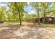 Charming home with an American flag, mature trees, screened porch and a long gravel driveway at 98 Cypress Pond Rd, Port Orange, FL 32128