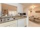 Kitchen view showcases the breakfast bar with stainless steel sink, cabinets, and open access to dining area at 98 Cypress Pond Rd, Port Orange, FL 32128