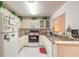 Bright kitchen features white appliances, ample cabinet space, and charming decorative accents at 98 Cypress Pond Rd, Port Orange, FL 32128