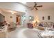 Bright living room with high ceilings, fan, and open access to the kitchen at 98 Cypress Pond Rd, Port Orange, FL 32128