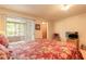 Spacious main bedroom with a queen size bed, slider to the lanai, and doorway to bathroom at 98 Cypress Pond Rd, Port Orange, FL 32128
