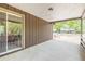 Covered patio perfect for outdoor seating, featuring a sliding glass door at 98 Cypress Pond Rd, Port Orange, FL 32128