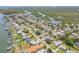 Waterfront homes showcase the neighborhood's coastal charm, nestled amongst mature trees and winding streets at 102 Inlet Shores Dr, New Smyrna Beach, FL 32168