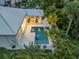 Bird's eye view of the home, pool, and patio in a lush tropical setting at 102 Inlet Shores Dr, New Smyrna Beach, FL 32168