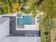 Aerial view of private pool, jacuzzi and lush tropical landscaping at 102 Inlet Shores Dr, New Smyrna Beach, FL 32168