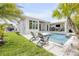 Backyard features a luxurious pool, built-in barbecue, and lounging areas at 102 Inlet Shores Dr, New Smyrna Beach, FL 32168