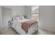 Bedroom with bright natural light, white wooden floors and ornate mirror at 102 Inlet Shores Dr, New Smyrna Beach, FL 32168