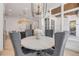 Elegant dining area featuring a round table, comfortable seating, and modern chandelier at 102 Inlet Shores Dr, New Smyrna Beach, FL 32168