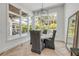Bright dining area featuring a table with comfortable seating, a mirror, and views of the backyard at 102 Inlet Shores Dr, New Smyrna Beach, FL 32168