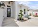 Close up of the front entrance with a modern black door and manicured landscaping with a rock feature at 102 Inlet Shores Dr, New Smyrna Beach, FL 32168