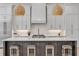 Bright kitchen features a large island with seating, modern appliances, and stylish pendant lighting at 102 Inlet Shores Dr, New Smyrna Beach, FL 32168