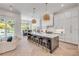 Bright, open kitchen with island seating, stainless steel appliances, and herringbone floors at 102 Inlet Shores Dr, New Smyrna Beach, FL 32168