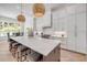 Bright kitchen features a large island with seating, modern appliances, and stylish pendant lighting at 102 Inlet Shores Dr, New Smyrna Beach, FL 32168