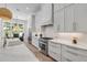 Bright kitchen featuring stainless steel appliances, white cabinetry, and a view to the dining area at 102 Inlet Shores Dr, New Smyrna Beach, FL 32168