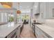 Bright, open kitchen with a large island, stainless appliances, and a view to the outdoor living area at 102 Inlet Shores Dr, New Smyrna Beach, FL 32168