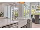 Bright kitchen featuring white countertops, a farmhouse sink, and stainless appliances at 102 Inlet Shores Dr, New Smyrna Beach, FL 32168