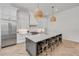 Bright kitchen with island seating, stainless steel appliances, and herringbone floors at 102 Inlet Shores Dr, New Smyrna Beach, FL 32168