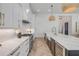 Open kitchen with island seating and stainless steel appliances and marble countertops at 102 Inlet Shores Dr, New Smyrna Beach, FL 32168
