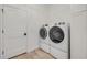 Convenient laundry room with modern washer and dryer units, built-in cabinetry, and neutral flooring at 102 Inlet Shores Dr, New Smyrna Beach, FL 32168