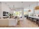 Spacious open-concept living room and kitchen with modern lighting and seamless indoor-outdoor flow at 102 Inlet Shores Dr, New Smyrna Beach, FL 32168