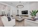 Open-concept living room with herringbone floors, fireplace, and stylish decor throughout at 102 Inlet Shores Dr, New Smyrna Beach, FL 32168