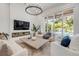 Bright living room with fireplace, herringbone floors, and access to a pool area at 102 Inlet Shores Dr, New Smyrna Beach, FL 32168