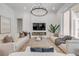 Bright living room with modern decor, a fireplace, large windows, and comfortable seating at 102 Inlet Shores Dr, New Smyrna Beach, FL 32168