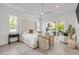 Bright main bedroom featuring an outdoor patio, chairs, and luxurious flooring at 102 Inlet Shores Dr, New Smyrna Beach, FL 32168