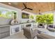 Outdoor kitchen includes a pizza oven, grill and cozy seating space at 102 Inlet Shores Dr, New Smyrna Beach, FL 32168