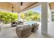 Covered outdoor space with ceiling fans, summer kitchen and view of the pool at 102 Inlet Shores Dr, New Smyrna Beach, FL 32168