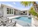 Beautiful backyard pool with outdoor kitchen and luxurious seating areas at 102 Inlet Shores Dr, New Smyrna Beach, FL 32168