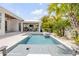 Inviting pool area features a covered patio and lush tropical foliage at 102 Inlet Shores Dr, New Smyrna Beach, FL 32168