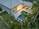 Aerial view showcasing a private backyard oasis with a pool, spa, outdoor seating, and lush landscaping at 102 Inlet Shores Dr, New Smyrna Beach, FL 32168