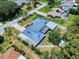 Overhead view of a well-maintained home with a unique metal roof, landscaped yard and convenient carport at 108 Dee St, New Smyrna Beach, FL 32168