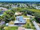 Lovely aerial of a community with a home boasting a metal roof and lush green landscaping at 108 Dee St, New Smyrna Beach, FL 32168
